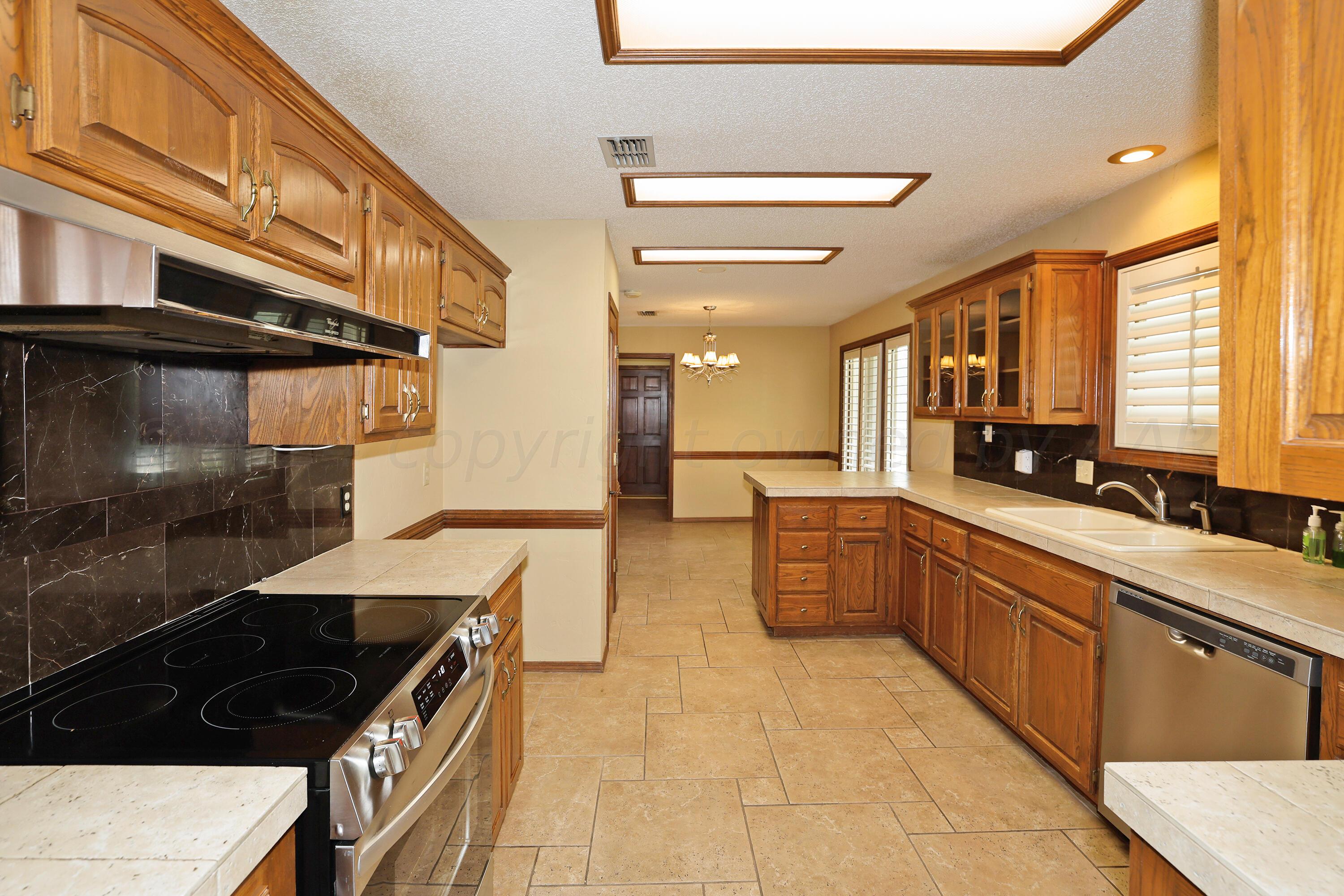 6819 Cloud Crest Drive Amarillo, TX 79124 - Photo 14 of 37 a kitchen with a sink and cabinets
