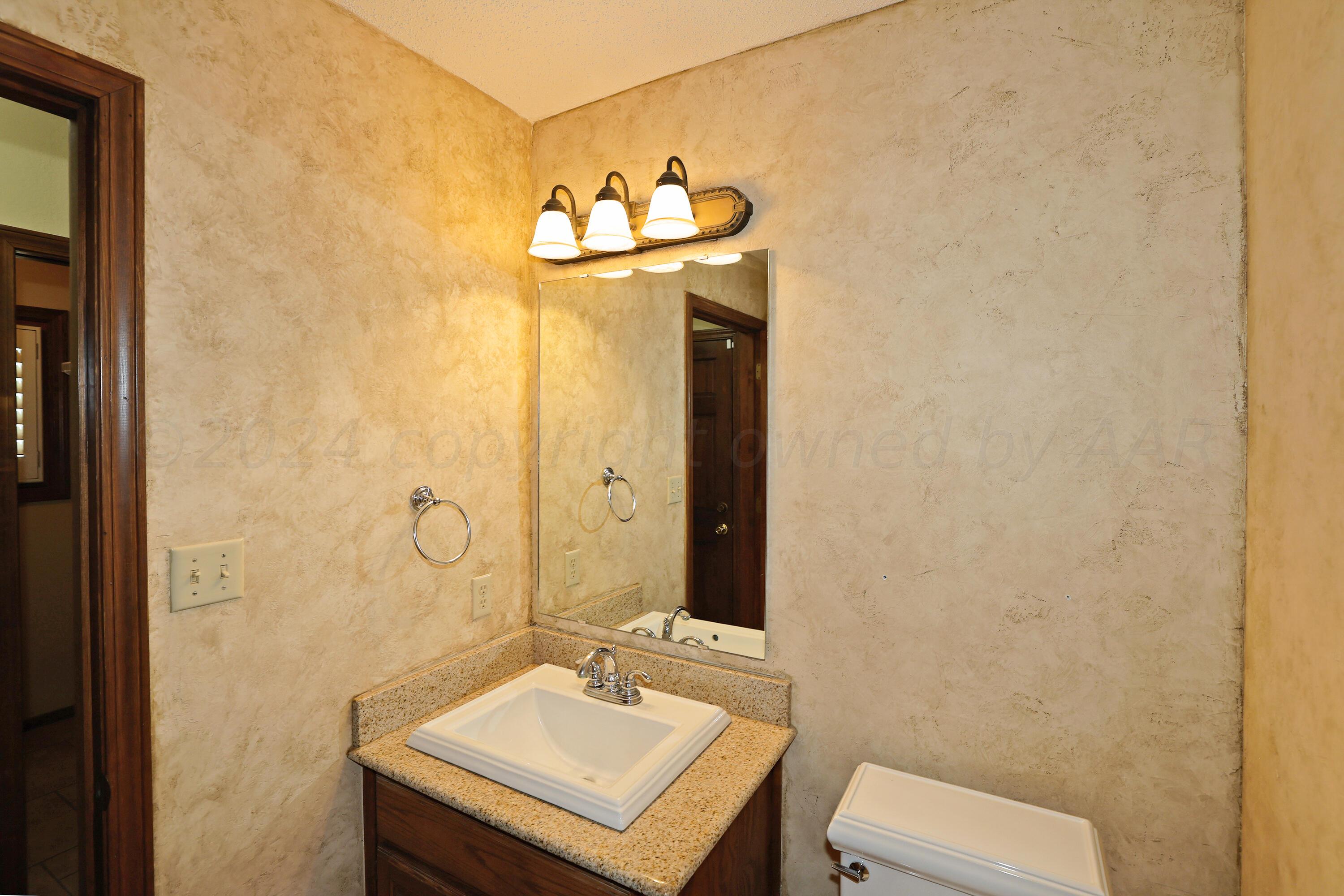 6819 Cloud Crest Drive Amarillo, TX 79124 - Photo 17 of 37 a bathroom with a sink and a mirror