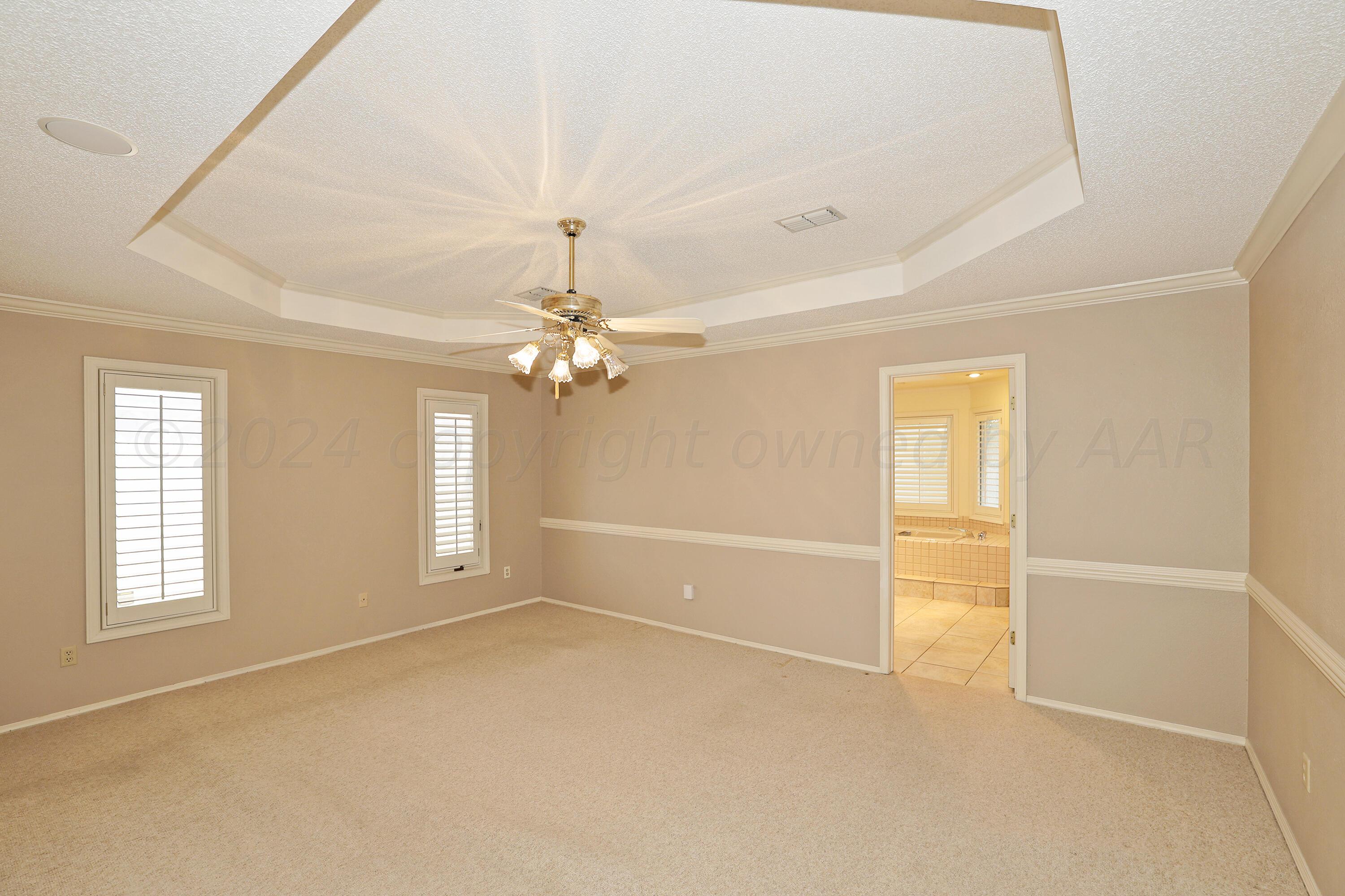 6819 Cloud Crest Drive Amarillo, TX 79124 - Photo 18 of 37 an empty room with windows and ceiling fan