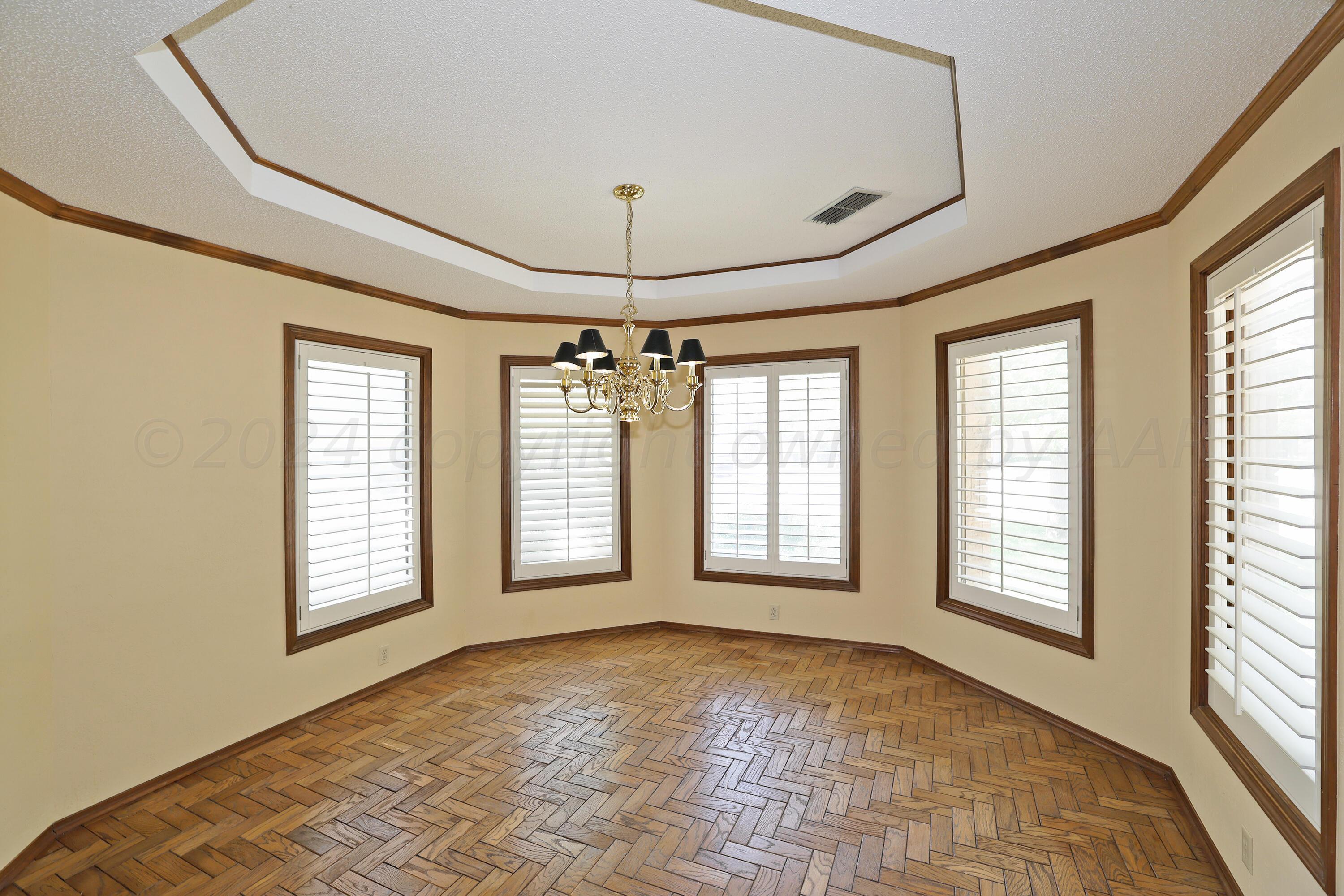 6819 Cloud Crest Drive Amarillo, TX 79124 - Photo 6 of 37 a view of an empty room with a window and chandelier fan