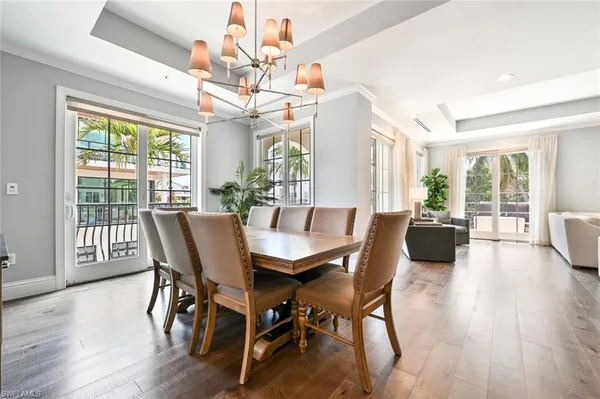 a view of a dining room with furniture wooden floor and chandelier