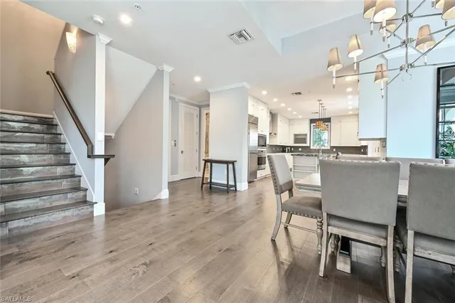 a dining room with furniture and wooden floor