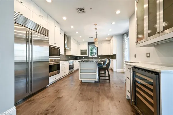a kitchen with stainless steel appliances a stove a sink and a refrigerator