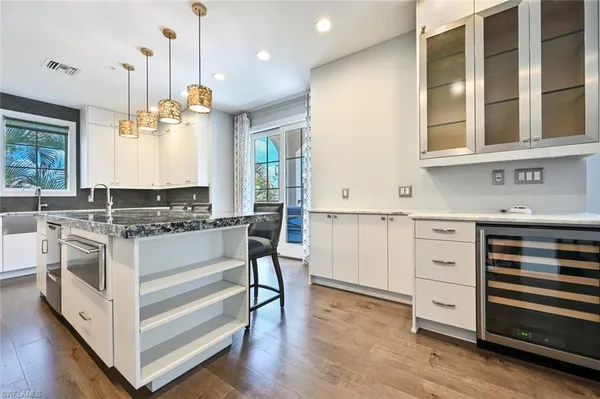 a kitchen with a stove window and cabinets