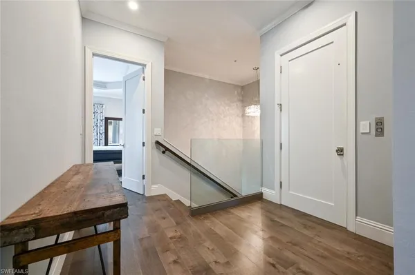 a view of a hallway with wooden floor and entryway