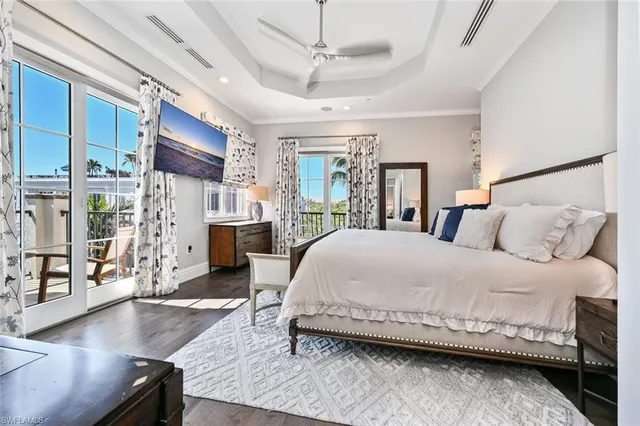 a bedroom with a large bed and a wooden floor