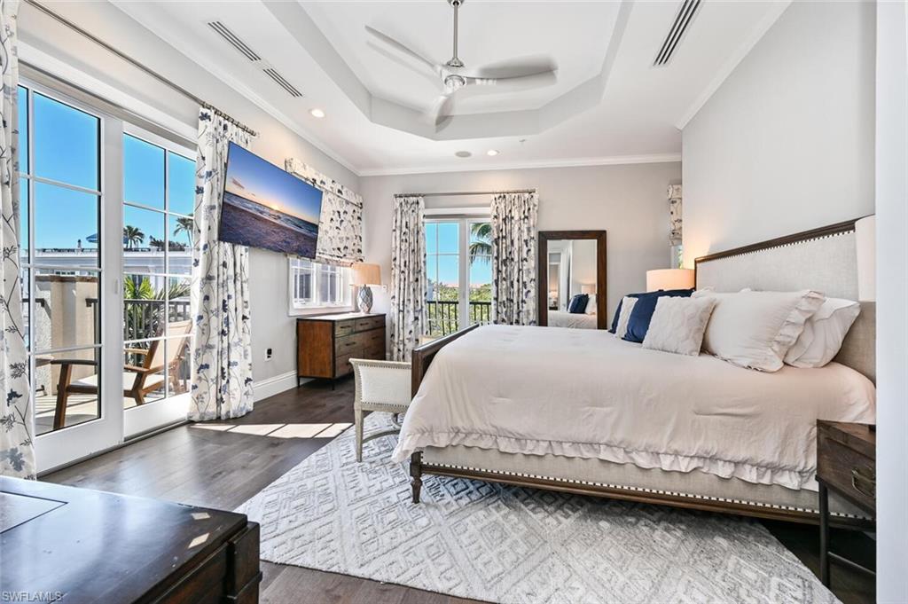 433 5th Street South Naples, FL 34102 - Photo 25 of 39 a bedroom with a large bed and a wooden floor