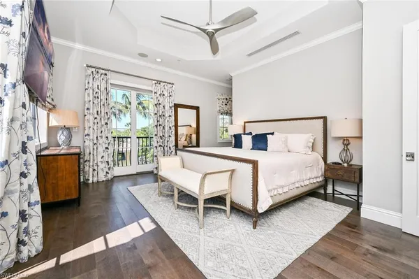 a bedroom with a bed wooden floor and window