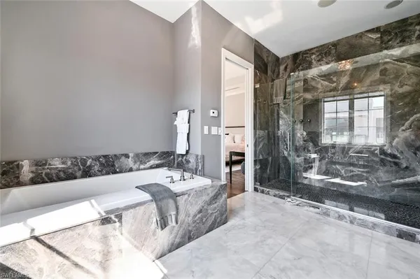 a spacious bathroom with a tub and shower