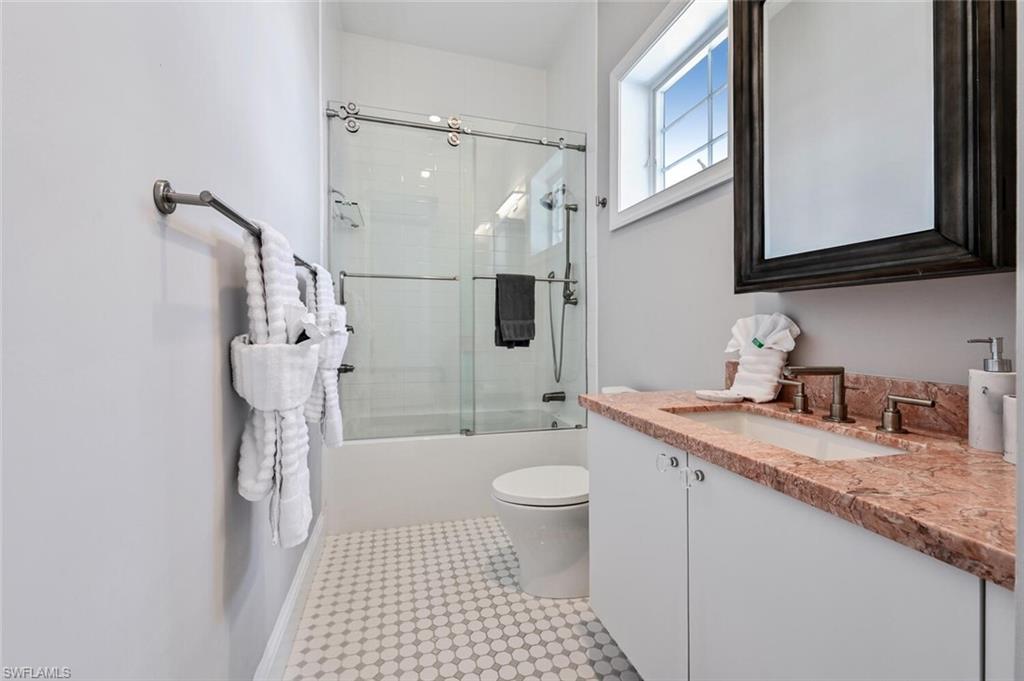 433 5th Street South Naples, FL 34102 - Photo 32 of 39 a bathroom with a sink a toilet and shower
