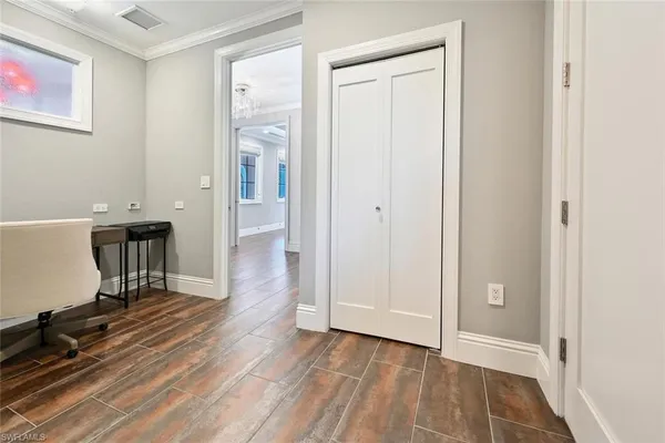 a view of a room with wooden floor and furniture