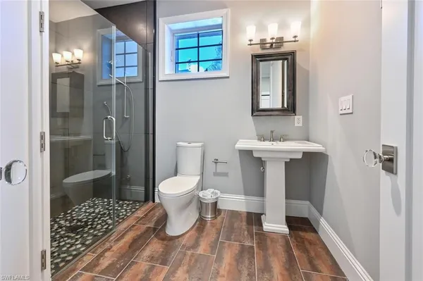 a bathroom with a sink toilet and shower
