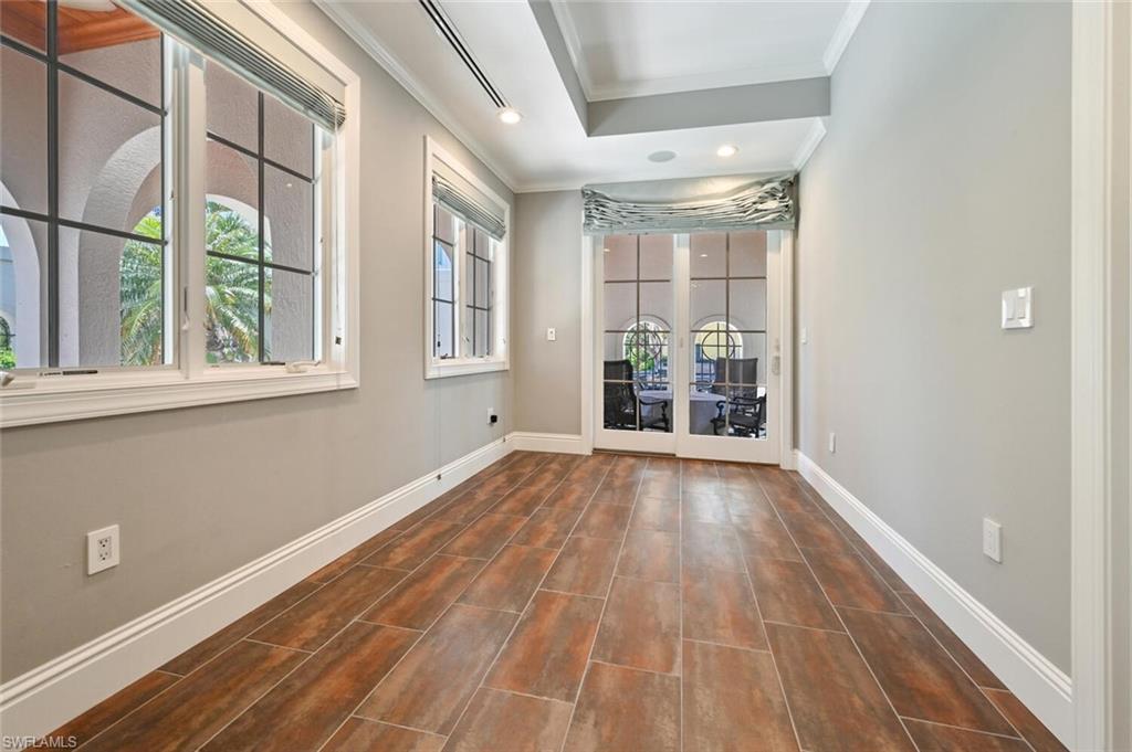 433 5th Street South Naples, FL 34102 - Photo 7 of 39 a view of an empty room with wooden floor and a window