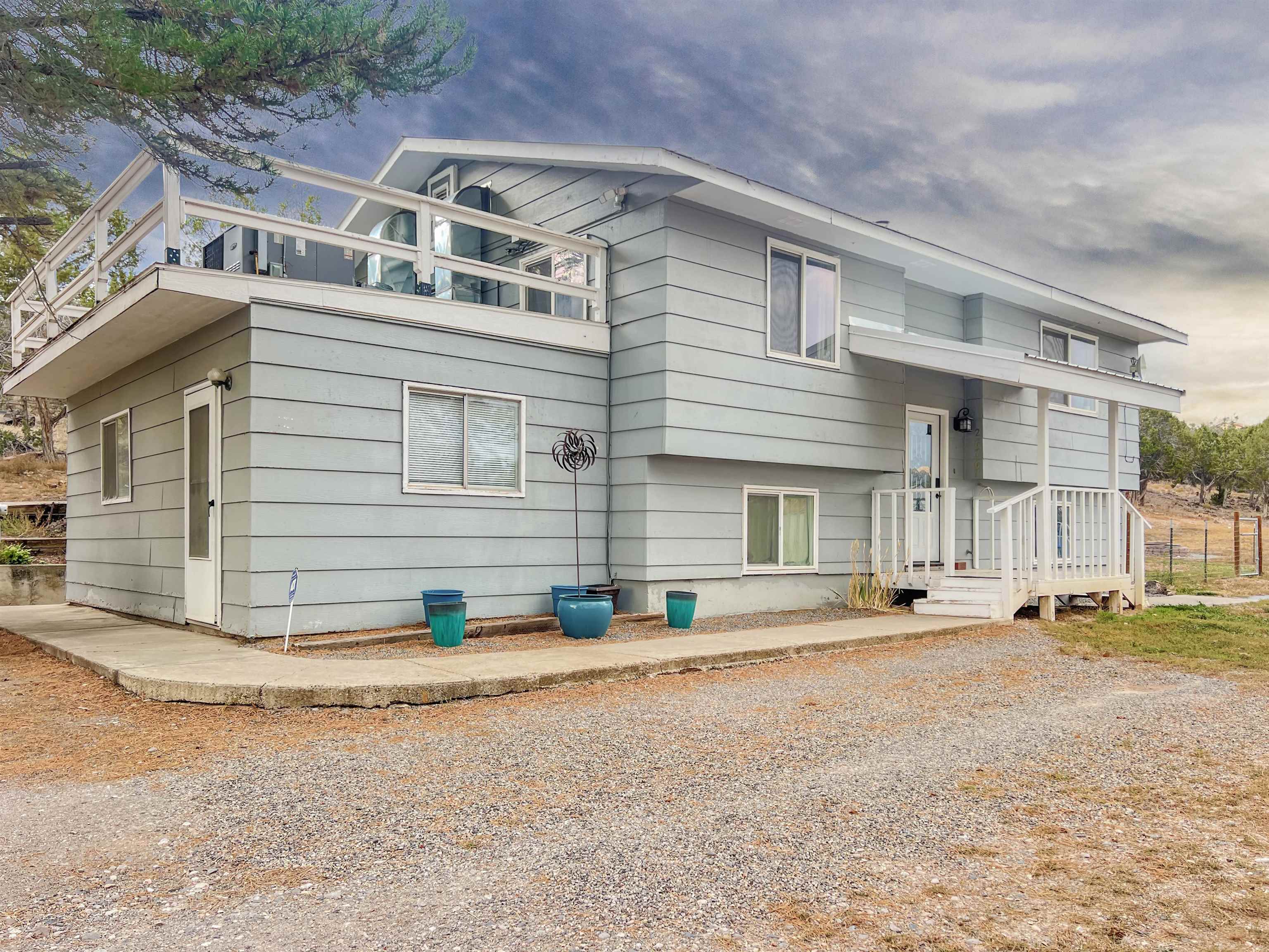26767 Cedar Mesa Road Cedaredge, CO 81413 - Photo 1 of 28 a front view of a house with a yard