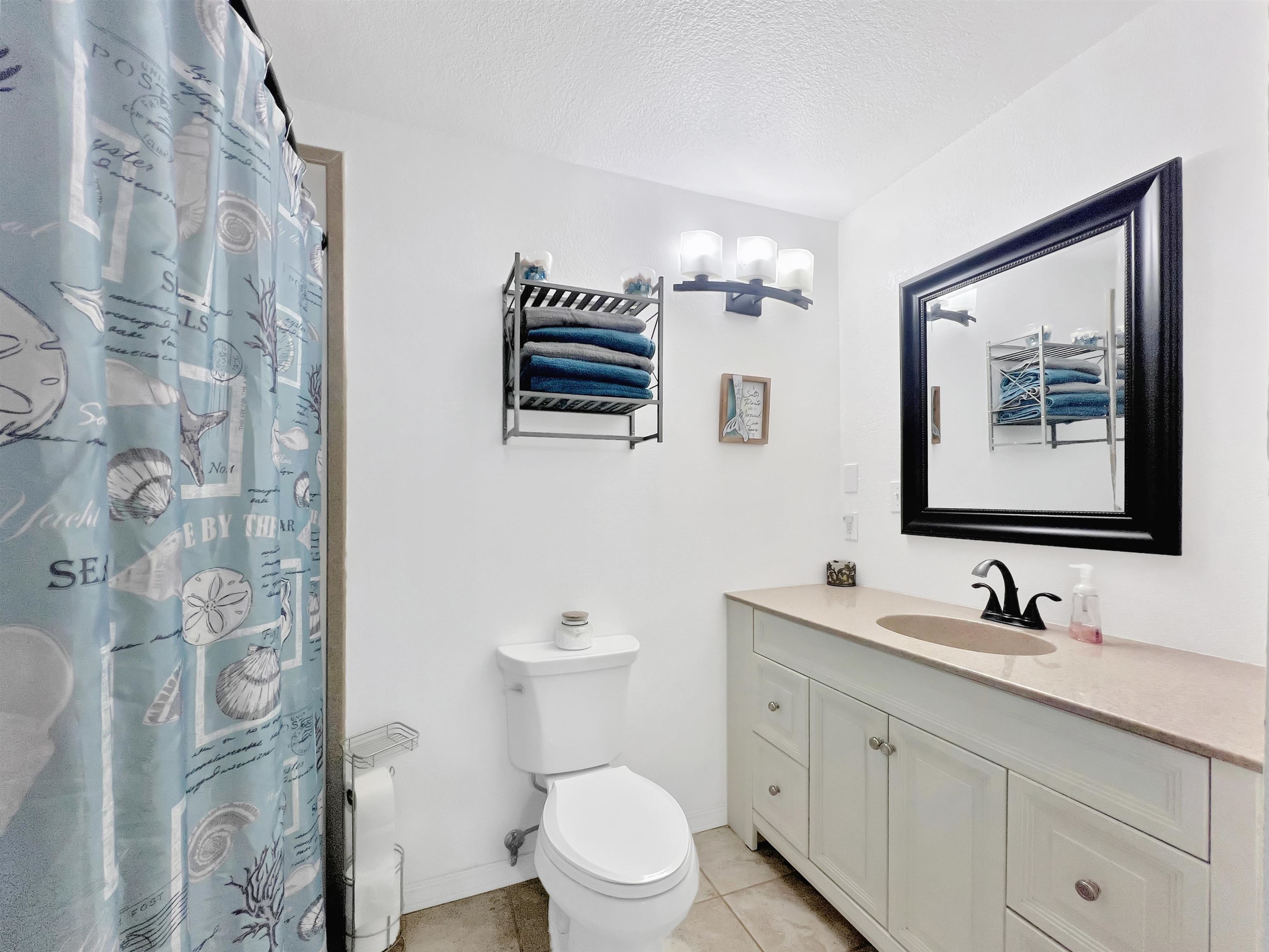 26767 Cedar Mesa Road Cedaredge, CO 81413 - Photo 14 of 28 a bathroom with a toilet sink and mirror