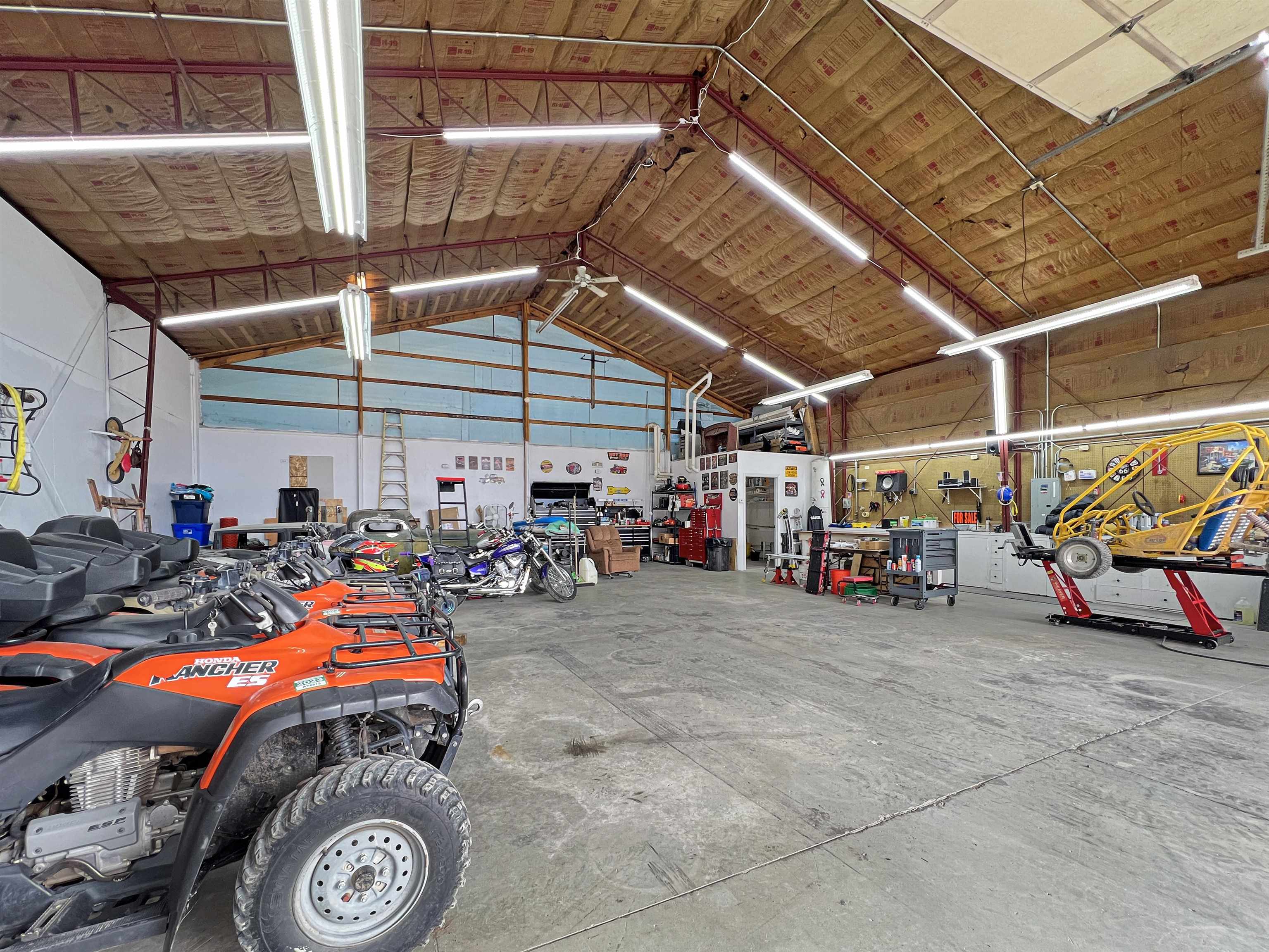 26767 Cedar Mesa Road Cedaredge, CO 81413 - Photo 22 of 28 a view of parking garage with cars and a bike