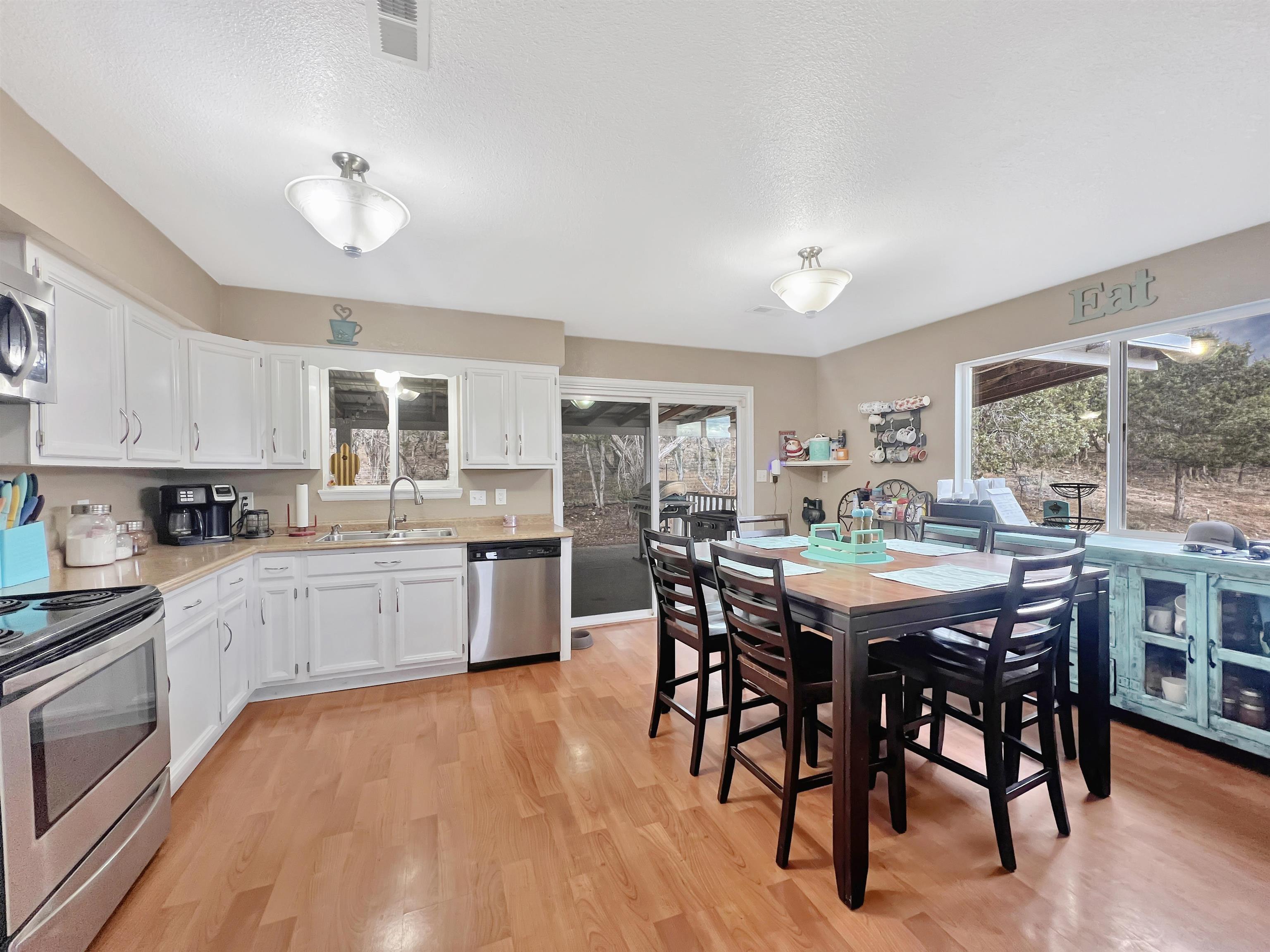 26767 Cedar Mesa Road Cedaredge, CO 81413 - Photo 5 of 28 a kitchen with stainless steel appliances granite countertop a dining table chairs stove a refrigerator and kitchen view