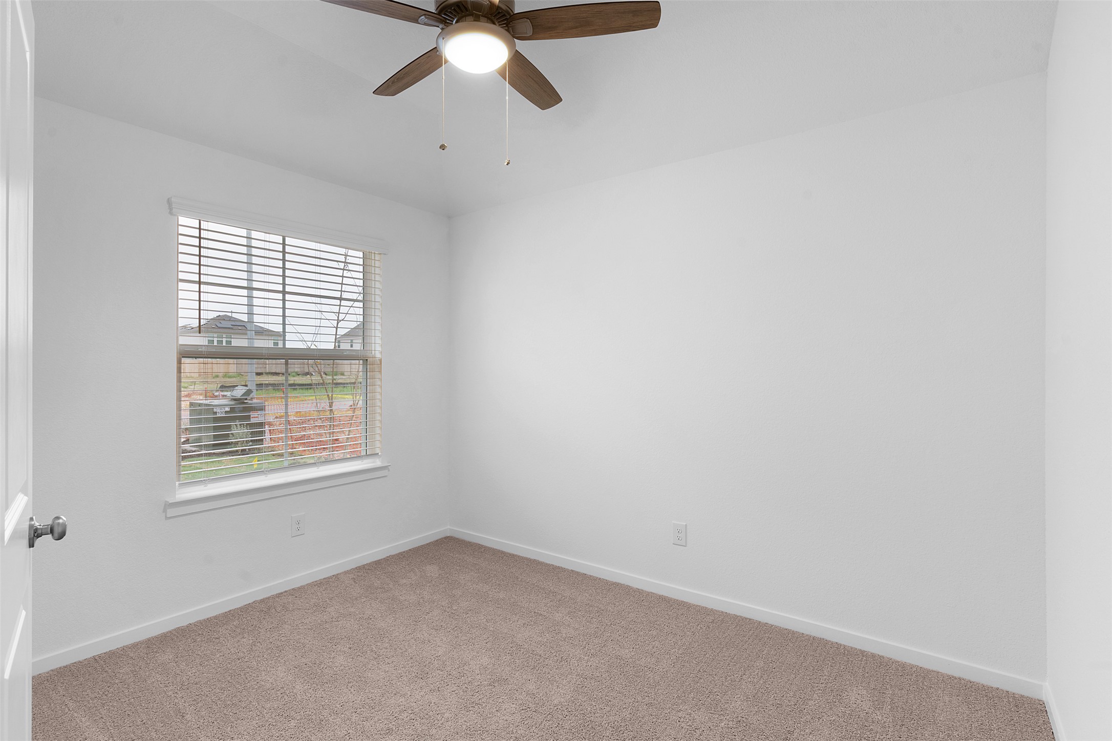 13721 Tucker Hedge Pass Elgin, TX 78621 - Photo 4 of 28 Carpeted spare room featuring baseboards and ceiling fan