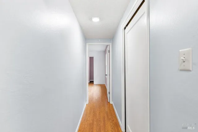 a view of a hallway with wooden floor