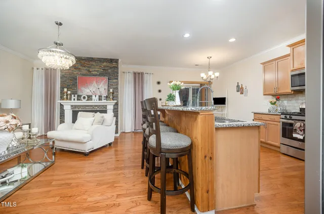 a living room with furniture dining table and a chandelier