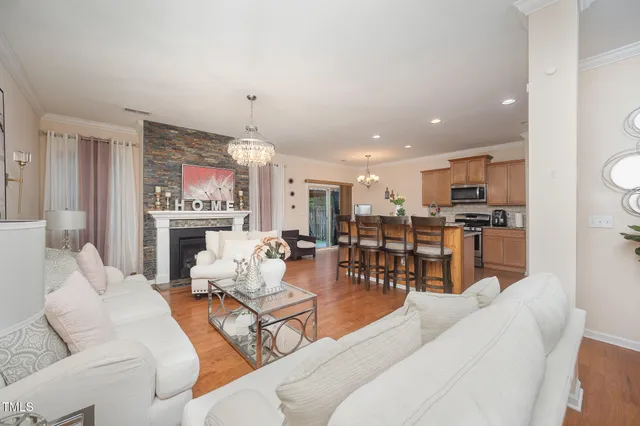a living room with furniture and a chandelier