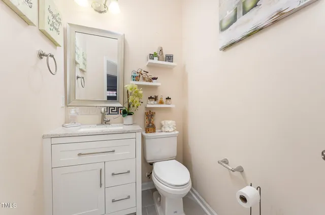 a kitchen with stainless steel appliances granite countertop a refrigerator a sink and white cabinets
