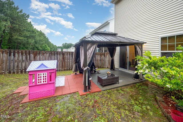 a view of a backyard with a slide and a table and chairs