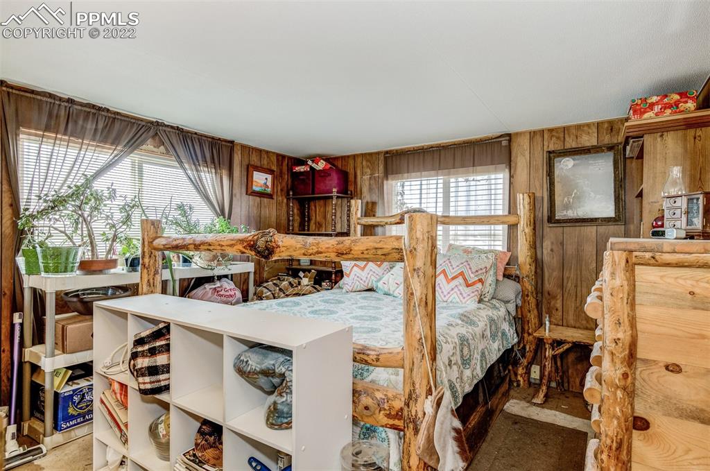 33895 East Jones Road Yoder, CO 80864 - Photo 19 of 45 a bed sitting in a bedroom next to a window