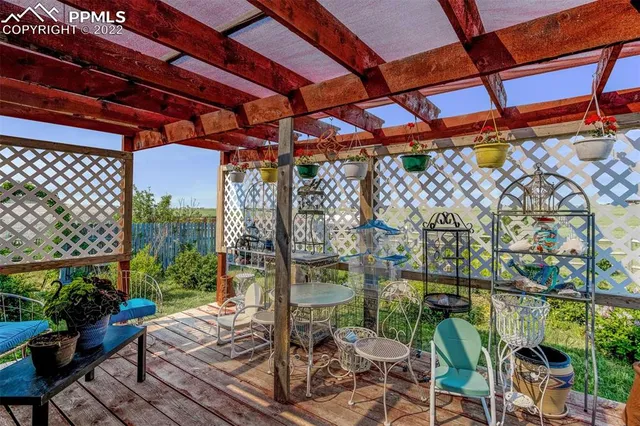 a view of a patio with table and chairs and potted plants