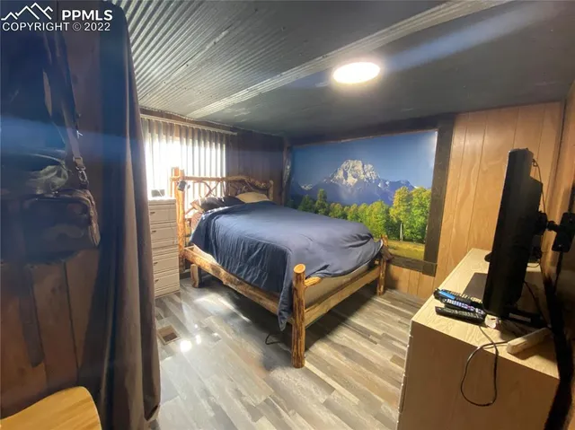 a bedroom with a bed window and a table