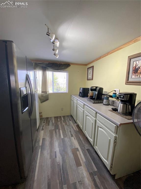 33895 East Jones Road Yoder, CO 80864 - Photo 22 of 45 a kitchen with cabinets and wooden floor