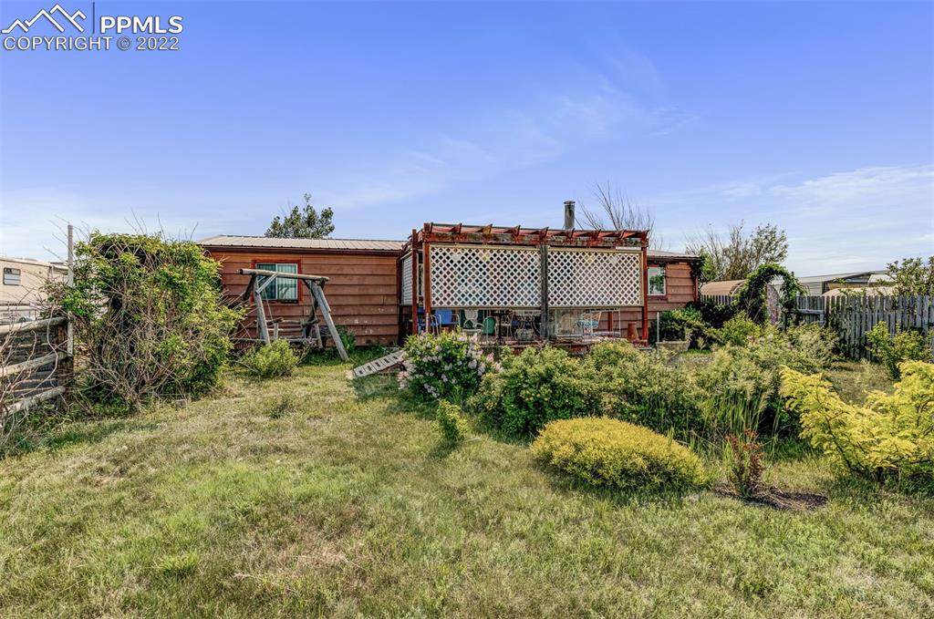 33895 East Jones Road Yoder, CO 80864 - Photo 3 of 45 a backyard of a house with a yard and outdoor seating