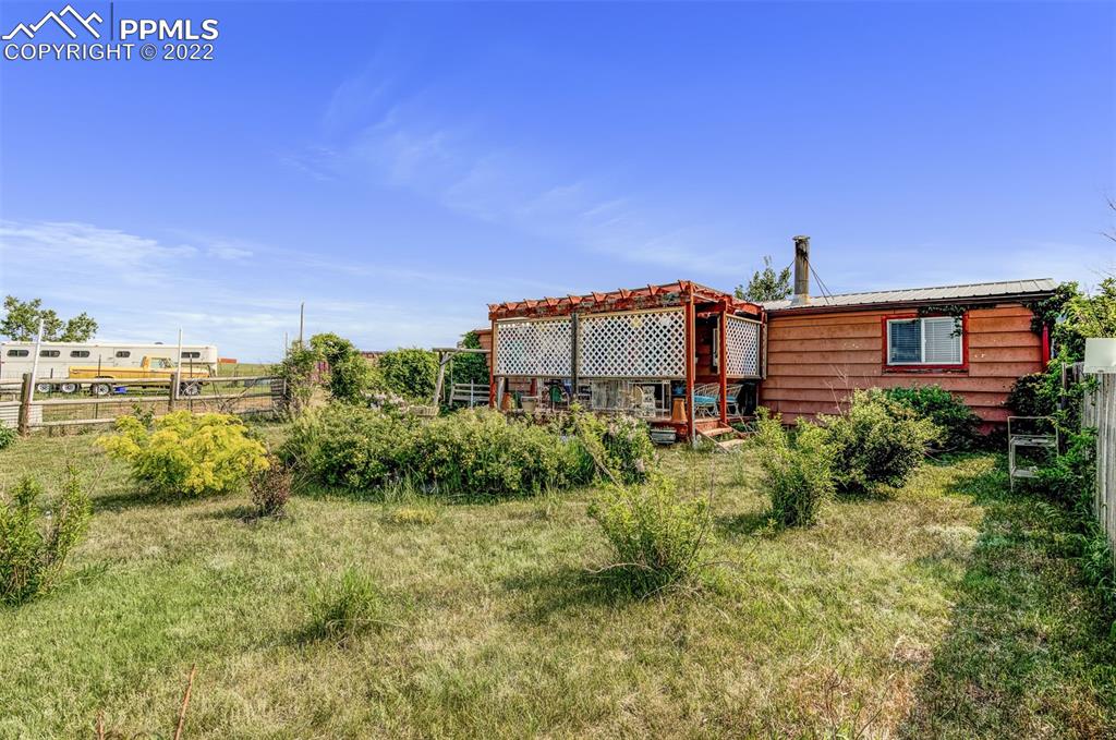 33895 East Jones Road Yoder, CO 80864 - Photo 7 of 45 a view of a big yard in front of a building