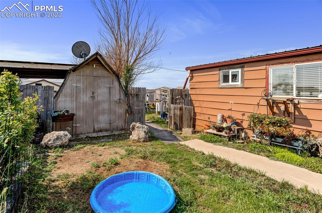 33895 East Jones Road Yoder, CO 80864 - Photo 9 of 45 a view of a backyard with table and chairs and a fire pit
