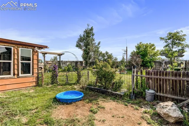 a backyard of a house with table and chairs