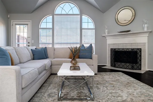 a living room with furniture a fireplace and window
