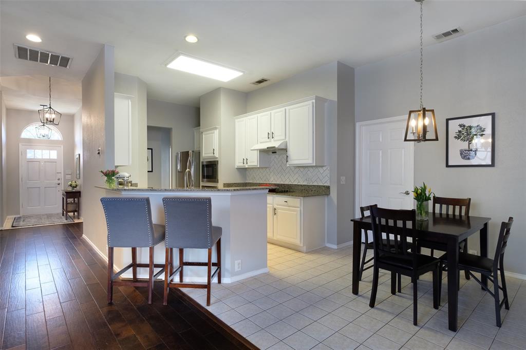 2513 Hunters Run Drive Plano, TX 75025 - Photo 11 of 36 a view of a dining room with furniture and wooden floor
