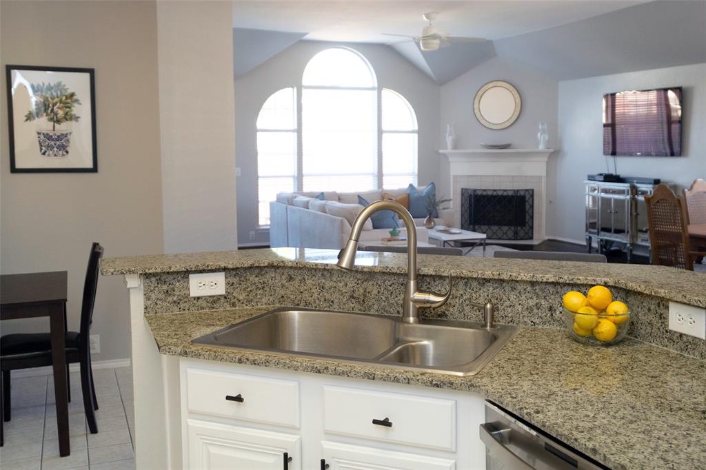 2513 Hunters Run Drive Plano, TX 75025 - Photo 15 of 36 a kitchen with a sink and a stove with wooden floor