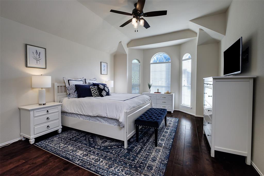 2513 Hunters Run Drive Plano, TX 75025 - Photo 18 of 36 a bedroom with a bed and a flat tv screen on dresser