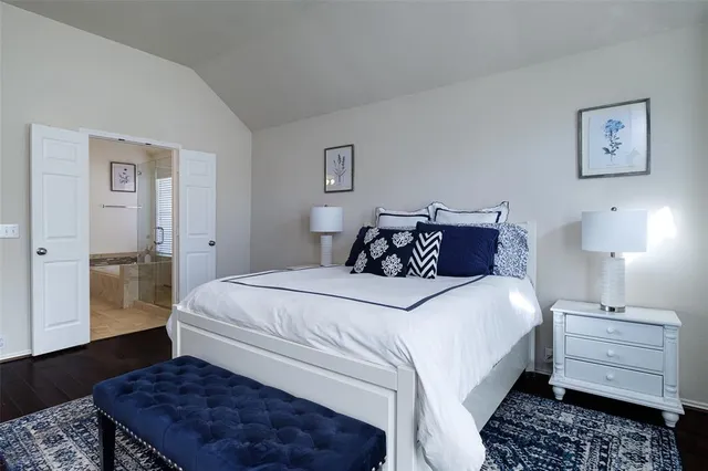 a bedroom with bed and wooden floor