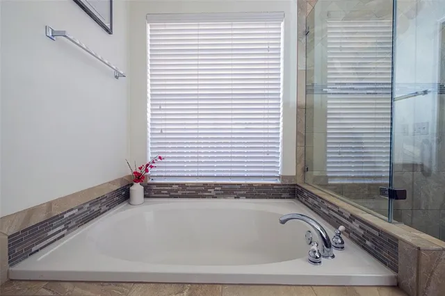 a bathroom with a bathtub and a window