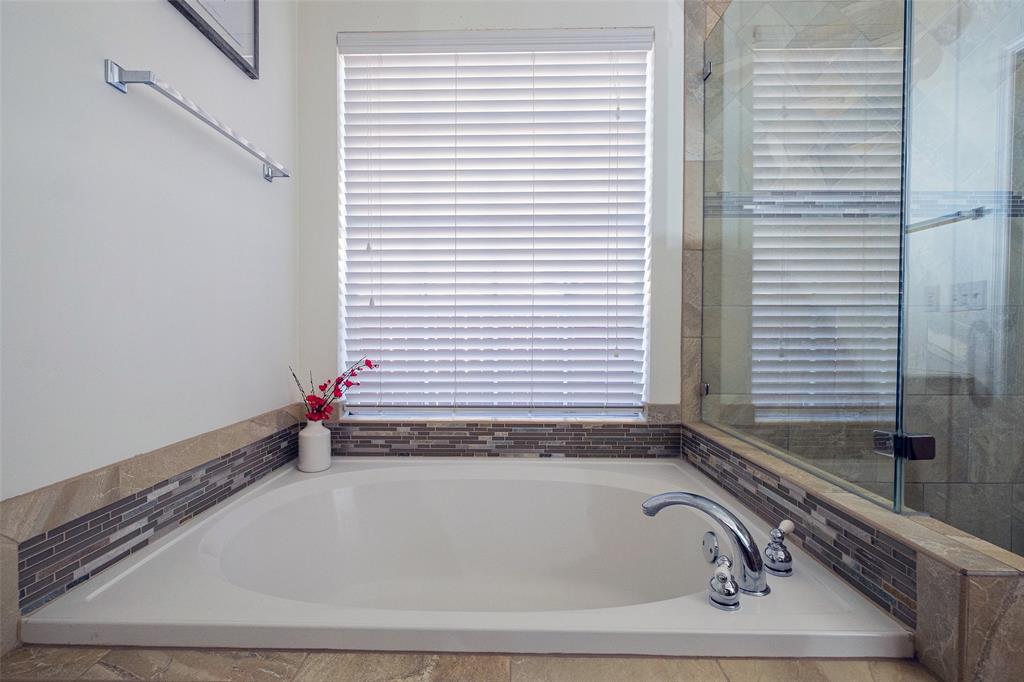 2513 Hunters Run Drive Plano, TX 75025 - Photo 23 of 36 a bathroom with a bathtub and a window