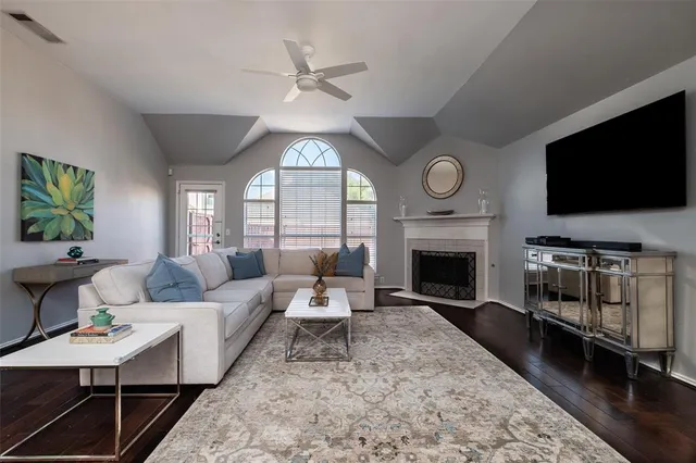 a living room with furniture a fireplace and a flat screen tv