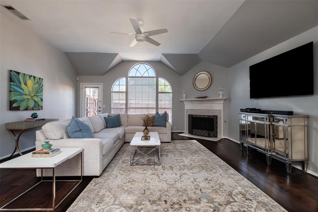 2513 Hunters Run Drive Plano, TX 75025 - Photo 3 of 36 a living room with furniture a fireplace and a flat screen tv