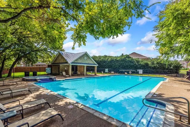 a view of a house with swimming pool and yard