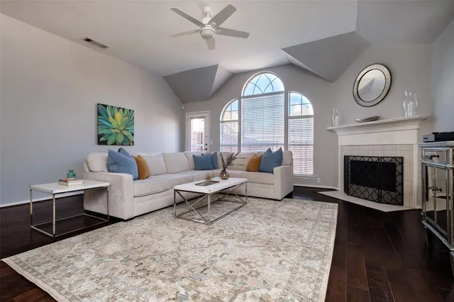 a living room with furniture a clock and a fireplace