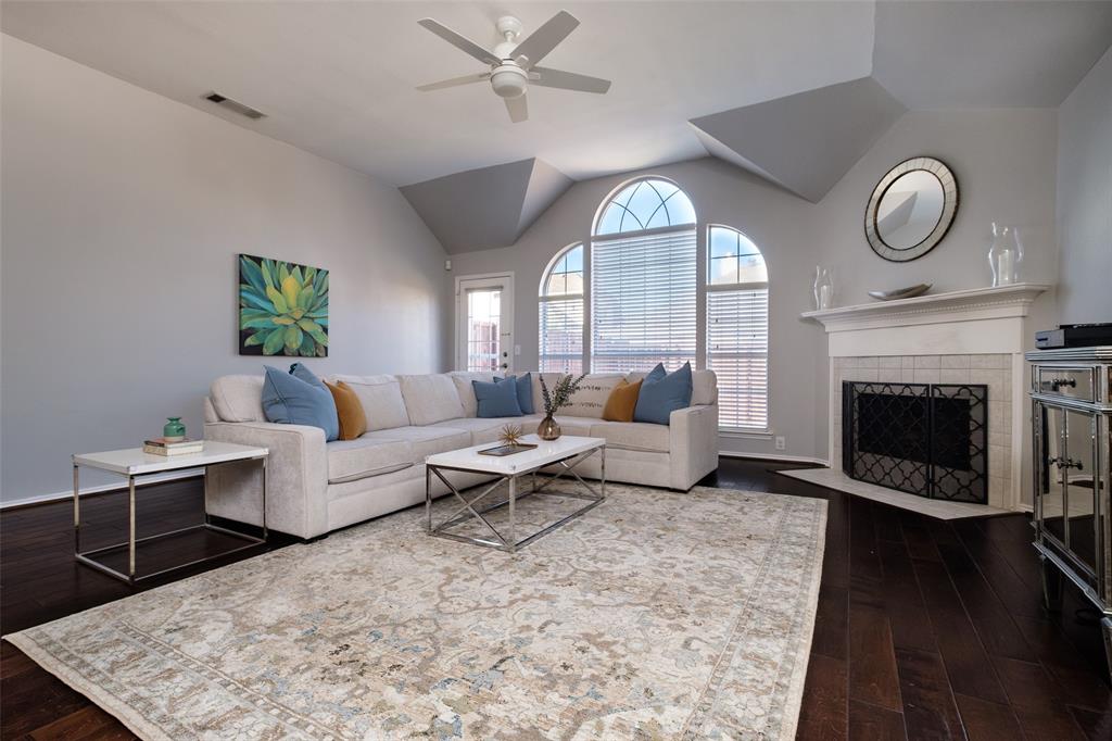 2513 Hunters Run Drive Plano, TX 75025 - Photo 5 of 36 a living room with furniture a clock and a fireplace
