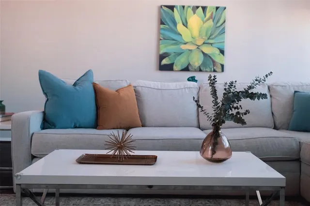 a view of a living room with furniture and a potted plant