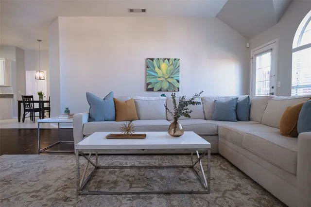 a living room with furniture and wooden floor