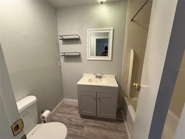 a bathroom with a sink toilet and mirror